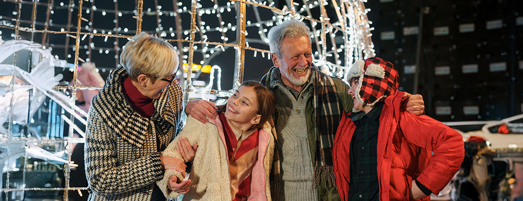 Image of senior man and woman out with their male and female grandchildren